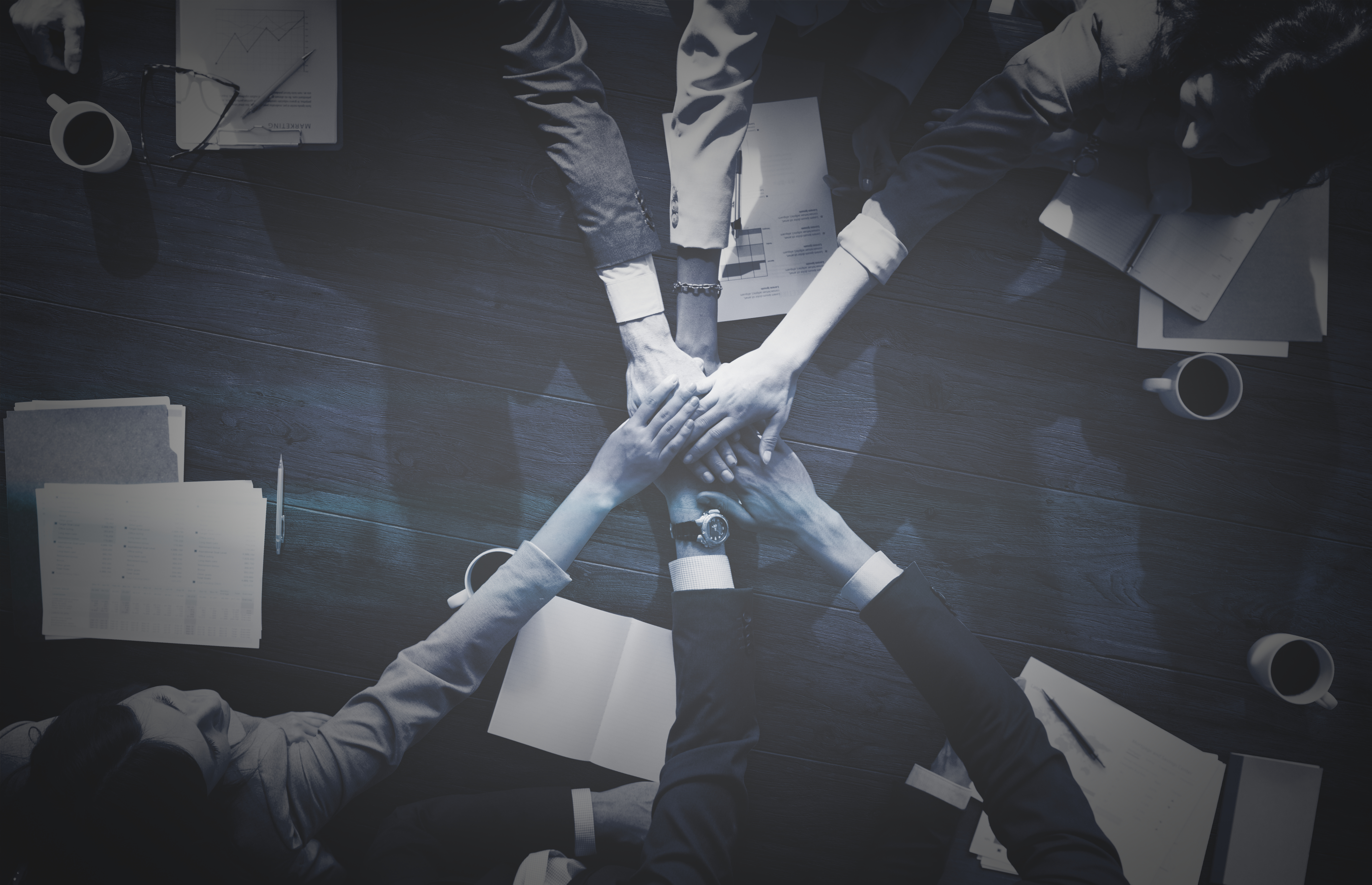 Business people stacking their hands Business people stacking their hands